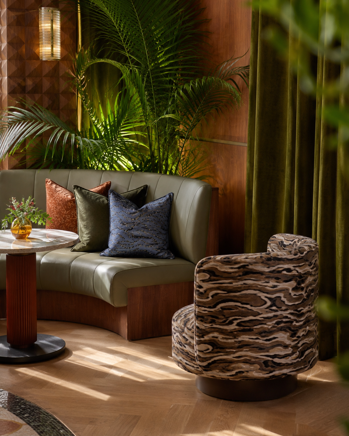 Curved banquette corner with olive leather and velvet curtain